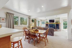 a living room with a table and chairs and a couch at South Village #8 in Warren
