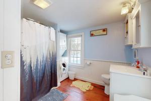 a bathroom with a sink and a toilet and a window at Ludlow's Gem in Ludlow +33 photos