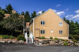 a large house with a staircase in front of it at Mountainside Resort: K105 in Stowe