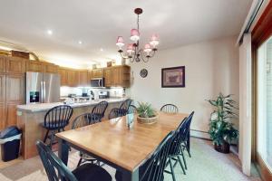 a kitchen and dining room with a wooden table and chairs at The Jay Chalet in Jay