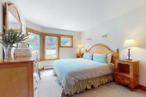 a bedroom with a bed and a dresser and windows at The Jay Chalet in Jay +43 photos