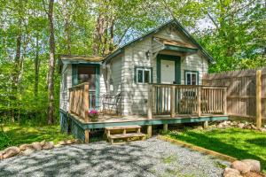 a tiny house in the woods with a porch at Davis Outpost Pet-Friendly Quiet Cabin w AC Screened Sunroom Walk to Trails in Otter Creek