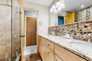a bathroom with a sink and a shower at Sugarbush River Home in Warren +35 photos