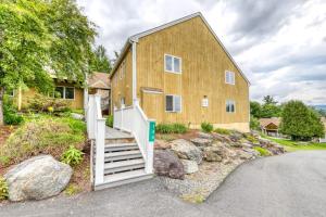 a large wooden house with a white door at Mountain View at Mountainside in Stowe