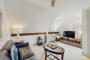 a living room with a couch and a table at Stowe Mountain Road Getaway in Stowe