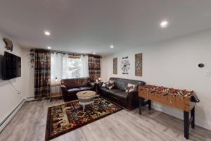 a living room with a couch and a table at Magic Birch Lodge in Windham