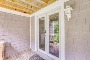 an empty room with a glass door in a house at Magic Birch Lodge in Windham +36 photos