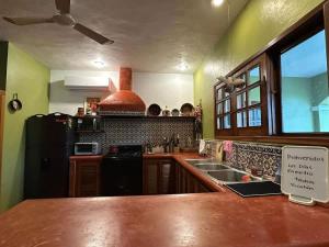 a kitchen with a counter top and a sink at Los Dias Enmedio in Telchac Puerto
