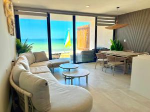 a living room with a couch and a table at Villa con rooftop para atardeceres in Telchac Puerto