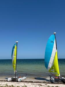 three sailboats sitting on the beach at Private villa among palms in Telchac in Telchac Puerto +6 photos