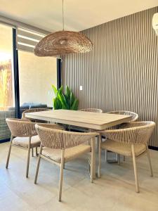 a dining room with a table and chairs at Villa oasis among the palms in Telchac Puerto
