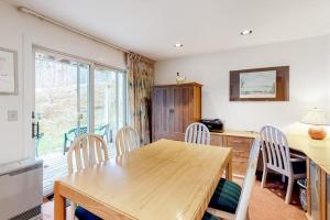 a kitchen and dining room with a wooden table and chairs at Vermont Paradise in Warren