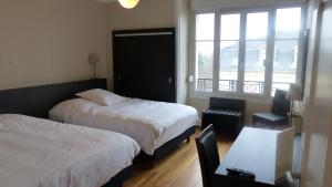 a hotel room with two beds and a window at Hotel De L'Europe in Toul +72 photos