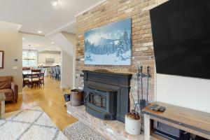 a living room with a fireplace with a flat screen tv at 366 Ghia Farm Road in Ludlow