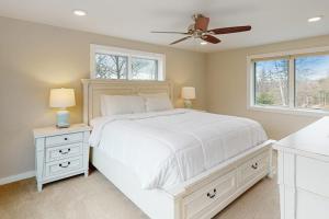 a bedroom with a white bed and a ceiling fan at 366 Ghia Farm Road in Ludlow