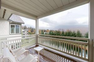 a porch with two chairs and a view of the mountains at Owls Unit #6 in Jeffersonville