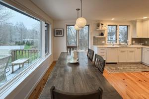 a kitchen with a long table and a large window at Londonderry Links in Londonderry