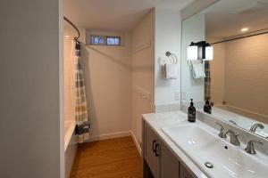 a bathroom with a sink and a large mirror at Londonderry Links in Londonderry +68 photos