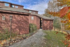 a brick house with a garage next to a driveway at Kettle Brook G in Ludlow
