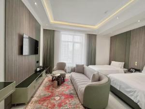 a hotel room with a couch and a bed at Ammar Hotel in Dushanbe
