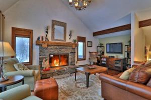 a living room with a fireplace and leather furniture at 375 Hawk Spur in Plymouth