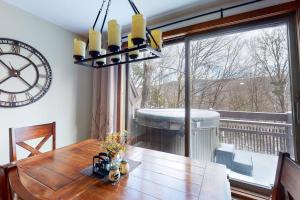 a dining room with a table and a large window at 375 Hawk Spur in Plymouth