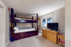 a bedroom with a bunk bed and a television at Solitude Village H103 in Ludlow +25 photos