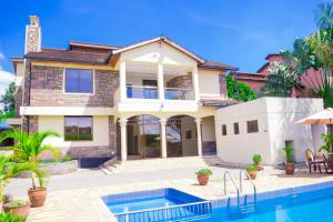 a house with a swimming pool in front of it at Sungura Villa in Nakuru