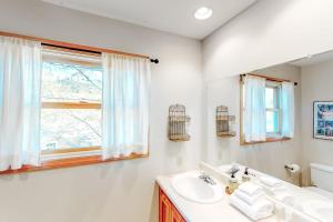 a white bathroom with a sink and a mirror at Wardsboro Family Escape in Wardsboro +58 photos