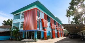 a colorful building on the side of a street at Veerakit Grand Hotel Udon Thani in Udon Thani