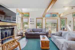 a living room with two couches and a fireplace at Haystack 32 in Wilmington