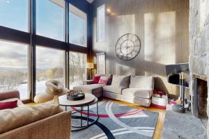 a living room with a couch and a fireplace at Deer Hill Retreat in Whitingham