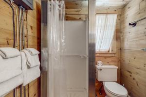 a bathroom with a toilet and a shower in it at Garden Island's Pine in Charlotte +45 photos