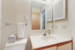 a white bathroom with a sink and a mirror at Cozy Sugarbush Getaway in Warren +27 photos
