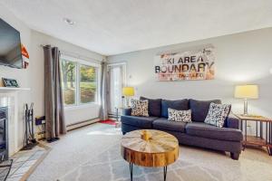 a living room with a blue couch and a table at Deer Creek 8A in Dover