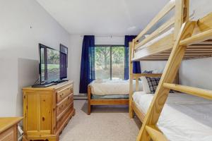 a bedroom with two bunk beds and a television at Deer Creek 8A in Dover