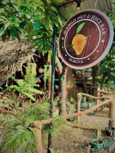 a sign for a juice bar in a garden at M D Travel Agent in Dambulla