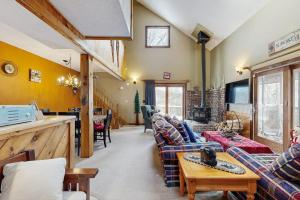 a large living room with couches and a tv at Snowy Day Chalet in Killington