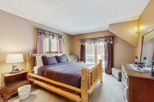 a bedroom with a large wooden bed in a room at Snowy Day Chalet in Killington