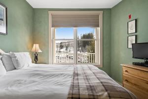a bedroom with a large bed and a window at Long Trail House 368 in Stratton +42 photos