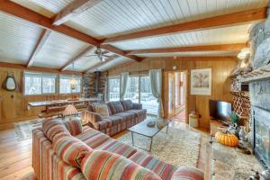a living room with couches and a fireplace at Mount Snow Chalet in West Dover