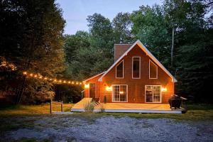 a house with a string of lights on it at Buckboard Haven in Dover