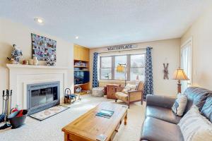 a living room with a couch and a fireplace at Winterplace Condos H in Ludlow