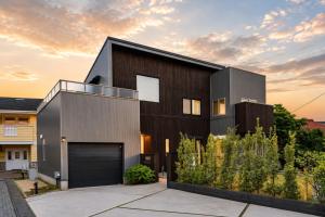 a modern house with a black garage at Rayful Hayama in Hayama