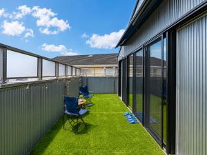 a balcony with two chairs and green grass at Rayful Hayama in Hayama +51 photos