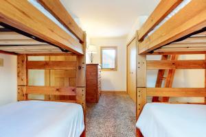 two bunk beds in a bedroom with wooden walls at 515 Cache in Jackson