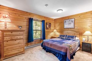 a bedroom with wooden walls and a bed and a window at The Breck House in Breckenridge