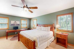 a bedroom with a bed and a ceiling fan at Big Bear Palace in Fraser