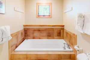 a bath tub in a bathroom with a window at Big Bear Palace in Fraser +69 photos