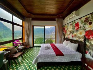 a bedroom with a bed and a large window at Tam Cốc mountain view Villa in Ninh Binh +63 photos